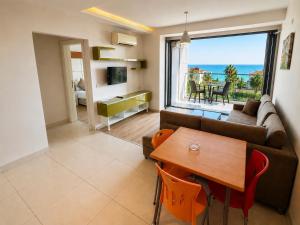 a living room with a couch and a table at Delfino Apart Hotel in Alanya