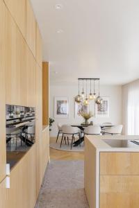 a kitchen and dining room with a dining table at The Edewallenaar in Kortemark