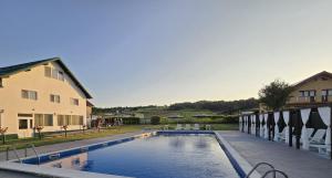 a large swimming pool next to a building at Casa Diadeea Motru in Motru