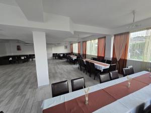 a large room with tables and chairs in it at Casa Diadeea Motru in Motru +27 photos