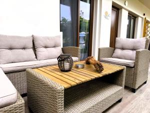 a patio with a table and wicker chairs at My Afytos Garden in Afitos