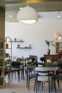 a group of tables and chairs in a room at Mostay Boutique Hotel in Mostar