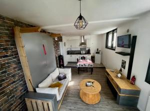 a living room with a couch and a table at Chez Rose in Ault