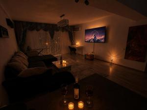 a living room with a couch and a table with candles at Panoramic Self Check-in Underground Parking in Iaşi