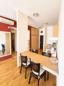 a kitchen and dining room with a table and chairs at SeaSideApartamn in Boreti