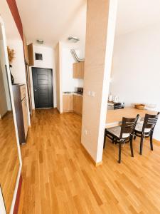 a living room with a table and chairs and a kitchen at SeaSideApartamn in Boreti