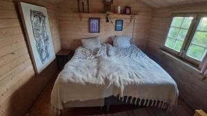 a bedroom with a bed in a log cabin at Paradise cottage w sea view in Brännöviken 5, Lögdeå in Lögdeå
