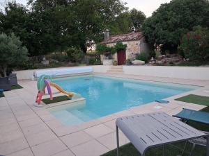 a swimming pool with a slide in the middle at La Piaule in Saint-Pierre-le-Vieux +13 photos