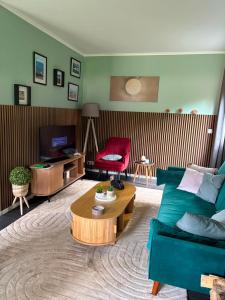 a living room with a couch and a coffee table at La Vida in Lanaken
