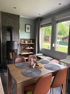a dining room with a table and a fireplace at La Vida in Lanaken