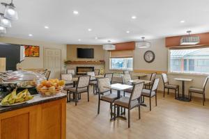 a large room with tables and chairs and a kitchen at SureStay Plus Hotel by Best Western Salmon Arm in Salmon Arm