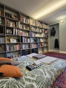 a bedroom with a bed in front of a book shelf at Loft Library by Lago Maggiore Rentals in Oggebio