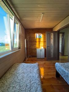 a bedroom with a bed and a window in a room at Мигдаль Маєток in Svityazʼ