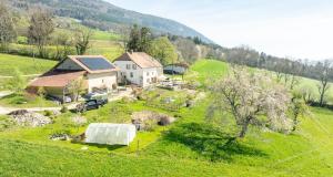 an aerial view of a house in a green field at Maison d hôtes Les Bruyères in Bonvillars