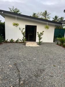a white building with a door in front of it at Hummingbird Haven in Uvita