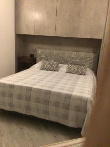 a bedroom with a bed with a checkered blanket at A due passi da Domodossola in Crevoladossola