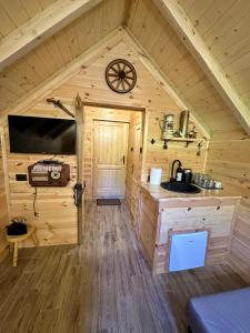 a cabin with a sink and a clock on the wall at Log Cabin in Blatina