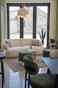 a living room with a couch and some chairs at Mostay Boutique Hotel in Mostar