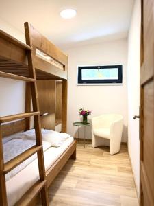 a bedroom with two bunk beds and a desk at JUNÁK MINI ubytování v soukromí in Vranov nad Dyjí