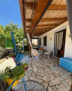 a patio with a table and chairs and a ceiling at Villa Gino in Santa Lucia