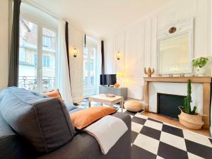 a living room with a couch and a fireplace at Le Chamily in Besançon