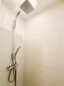 a shower in a bathroom with a shower head at Le Chamily in Besançon
