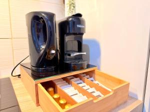 a coffee maker sitting on top of a wooden stand at Le Chamily in Besançon +6 photos