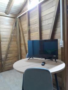 a desk with a television on top of a table at Studio LAVANDES in Lamentin