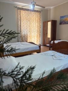 a room with two beds and a window at San Marco in Velipojë