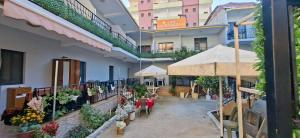 a balcony with an outdoor market with flowers and plants at San Marco in Velipojë