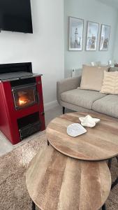 a living room with a coffee table and a stove at Rose Cottage, Killala in Killala +11 photos
