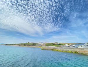 a view of a body of water with a cloudy sky at Rose Cottage, Killala in Killala