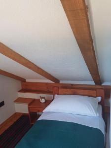 a bedroom with a bed and a wooden ceiling at Terra Verde in Omiš