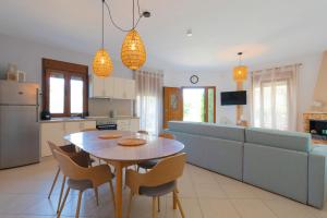 a kitchen and living room with a table and chairs at Villa Nostalgia in Skala Potamias
