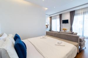 a bedroom with a large bed and a couch at Arte Luxury Pool Apartmets in Ulcinj +88 photos