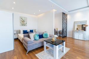 a living room with a couch and a table at Arte Luxury Pool Apartmets in Ulcinj