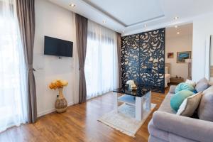 a living room with a couch and a table at Arte Luxury Pool Apartmets in Ulcinj