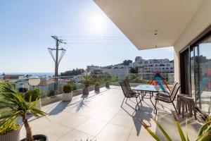 a patio with a table and chairs on a balcony at Arte Luxury Pool Apartmets in Ulcinj