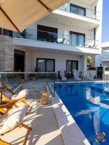 a villa with a swimming pool and a house at Arte Luxury Pool Apartmets in Ulcinj