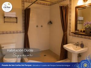 a bathroom with a sink and a toilet and a mirror at Posada de San Carlos del Parque in Antigua Guatemala +29 photos