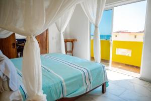 a bedroom with a bed and a large window at Happy Beach - Playa Feliz in Ixtapa-Zihuatanejo International +115 photos