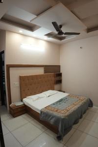 a bedroom with a bed and a ceiling fan at Hotel Hari Sarovar in Kurukshetra +10 photos
