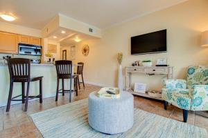 a living room with a tv and a kitchen at Waterfront, Sunset views from balcony, Heated pool in Tampa