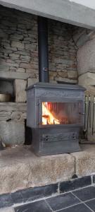 a stone oven with a fire inside of it at Green Acres Bretagne in Maël-Carhaix