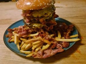 a plate of food with a hamburger and french fries at 5 person holiday home in Aabybro in Åbybro