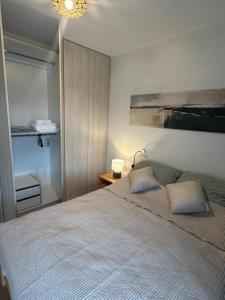 a bedroom with a large bed with two pillows at Apartamenty Wichrowa in Żywiec