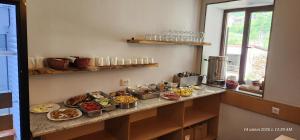 a kitchen with plates of food on a counter at hotel "Riverside Mestia" in Mestia +26 photos