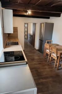 a kitchen with a stove and a table with chairs at Klidná Chalupa in Bulhary