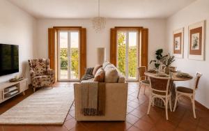 a living room with a couch and a table at Iconic Vila d'Obidos in Óbidos