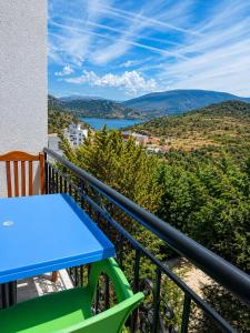 a balcony with a table and a view of a lake at Villa Festim Ksamil in Ksamil